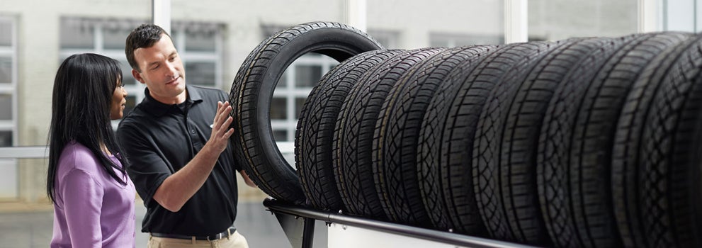 Subaru service representative showing customer a tire. | Mark Miller Subaru Midtown in Salt Lake City UT